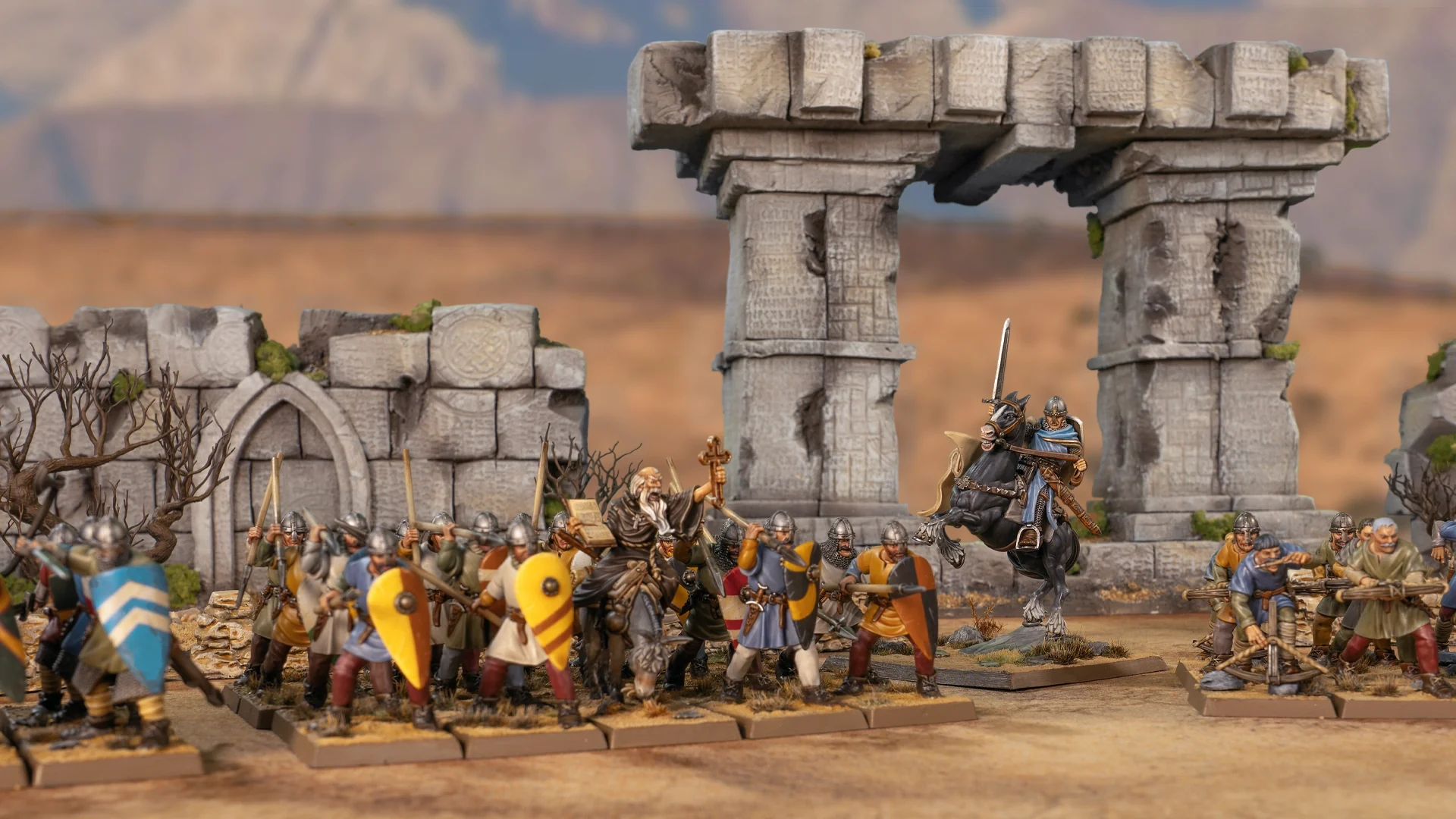 Painted Crusader miniatures before ruins